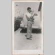 Man carrying a baby (ddr-manz-10-93)