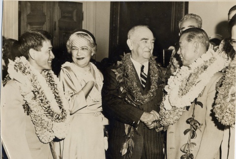Samuel Wilder King and wife with two men wearing leis (ddr-njpa-2-545)