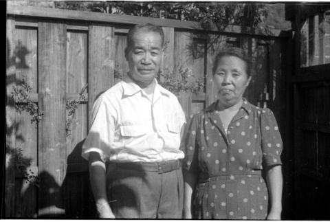 Man and woman standing by fence (ddr-densho-426-1123)