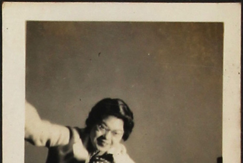 Tomoye (Nozawa) Takahashi posing with toy stuffed horse (ddr-densho-423-538)