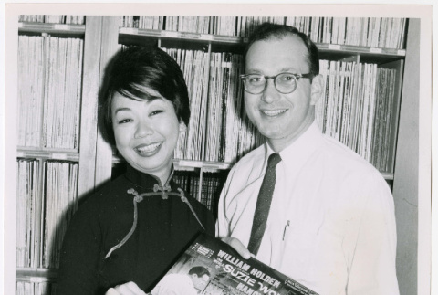 Mary Mon Toy with man holding album soundtrack for The World of Suzie Wong film (ddr-densho-367-187)