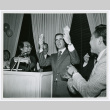 Jerry Brown holding up a broken fortune cookie (ddr-densho-499-32)