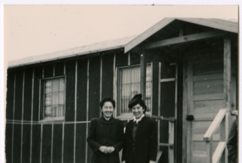 Two Japanese American women at barracks steps (ddr-densho-362-55)