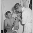 Japanese American doctor examining patient (ddr-densho-151-422)