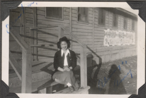 Woman sitting on steps of barracks (ddr-densho-466-219)