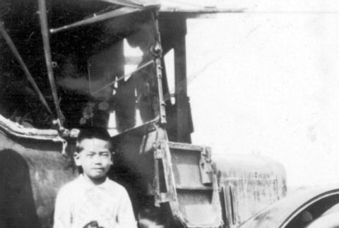 Two boys near a Model T Ford (ddr-densho-12-16)