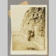 People emerging from a shelter[?] built into a cliff face (ddr-njpa-13-1515)