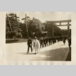 A Shinto priest leading men in uniform through the gates of a shrine (ddr-njpa-8-49)