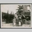 Family poses in front of monument (ddr-densho-359-966)