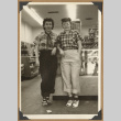 Two women leaning against a counter (ddr-densho-542-122)