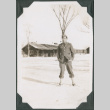 Man with pipe standing in snow (ddr-ajah-2-470)