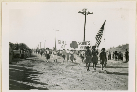 Girls Scouts march in an Armistice Day parade. (ddr-densho-37-1175)