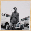 Hardy Shiomi standing next to car (ddr-densho-522-313)