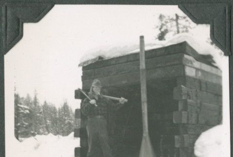 Man standing by shed (ddr-ajah-2-318)