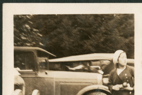 Woman by row of cars (ddr-densho-316-194)