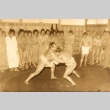 Two sumo wrestlers fighting while others look on (ddr-njpa-4-9)