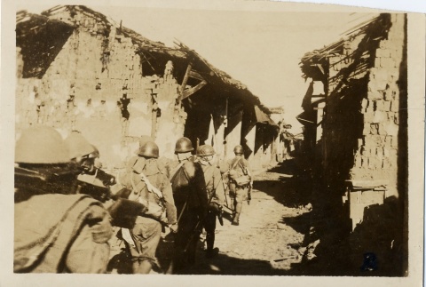 Troops walking between ruined buildings (ddr-njpa-6-10)