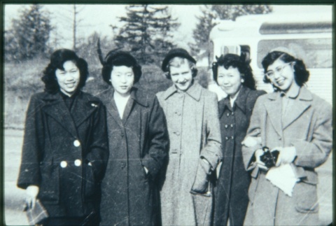 Five women in coats in front of bus (ddr-densho-330-134)