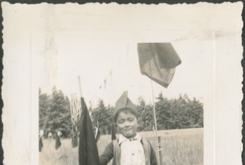A boy holding a flag (ddr-densho-321-822)