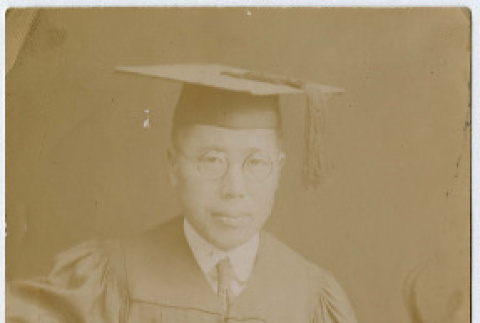 Photo of Gentaro Takahashi in graduation robes (ddr-densho-355-136)