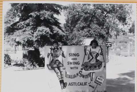 Leslie and Susan Shiomi behind novelty sign (ddr-densho-522-588)