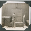 Man standing outside door of building (ddr-ajah-2-460)