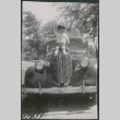 Boy sitting on hood of car (ddr-densho-523-212)