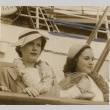 Paulette Goddard and another woman wearing leis on a ship (ddr-njpa-1-508)