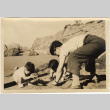 Man and two children playing on a beach (ddr-densho-426-43)
