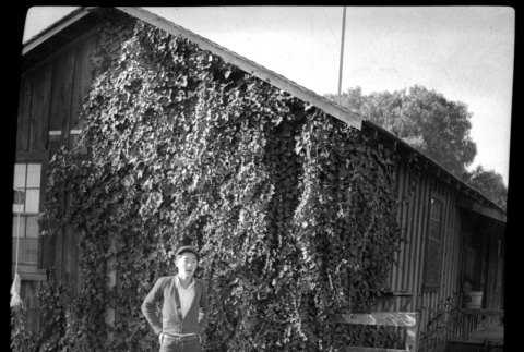 Young man in front of ivy-covered building (ddr-densho-475-127)