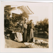 Two men standing in garden by large rock (ddr-densho-426-2076)
