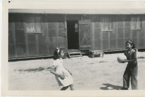 Two girls playing with a ball (ddr-manz-7-24)