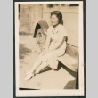 Woman sitting on running board of a car (ddr-densho-433-792)