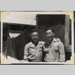 Two men standing outside barracks (ddr-densho-466-854)