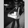 Man selling bento boxes at train station (ddr-densho-426-2299)
