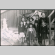 Nine young Japanese American girls take group photo near camp barracks steps (ddr-densho-362-38)