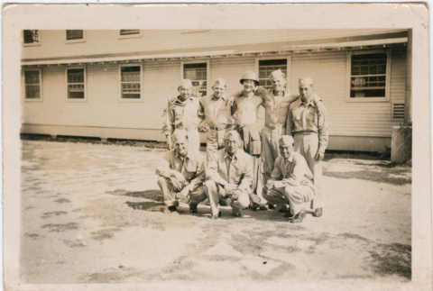 Eight men in uniform outside army barracks (ddr-densho-458-48)