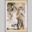 Three children eating watermelon (ddr-densho-483-1079)