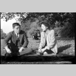 Tomoyuki Nozawa and Tomoye (Nozawa) Takahashi seated on a blanket in a park (ddr-densho-426-1739)