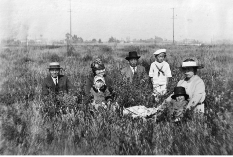 Takuritsu Morita with friends sitting in field (ddr-ajah-6-620)