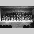 Minidoka High School students seated on an auditorium stage (ddr-fom-1-472)