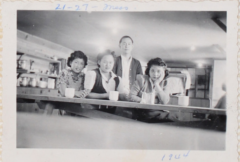 Three women and a man in mess hall (ddr-densho-464-74)