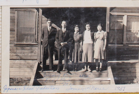 Two men and three woman on steps of wooden building (ddr-densho-464-131)
