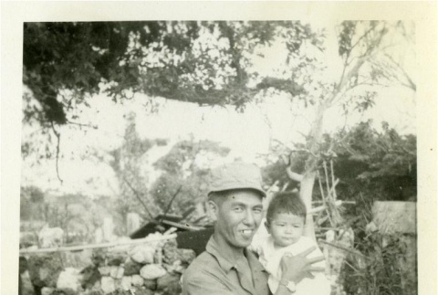 Nisei soldier holding a child (ddr-densho-179-68)