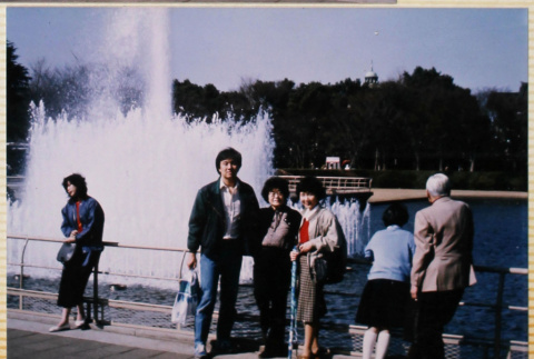 Three people standing by fountain (ddr-densho-422-588)