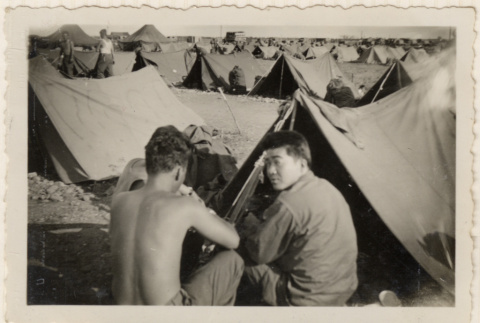 Three men sitting outside tent (ddr-densho-466-384)