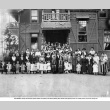 Large group of adults and children posing outside building (ddr-ajah-3-171)