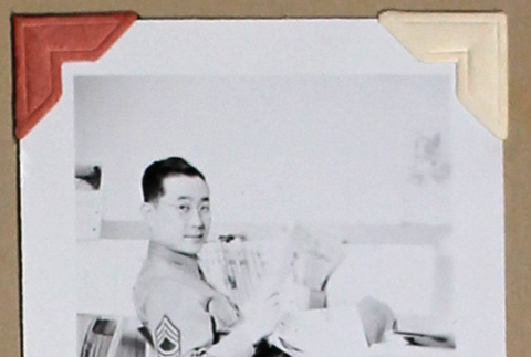 Man in military uniform reads a newspaper (ddr-densho-404-396)