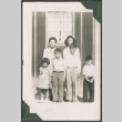 A family in front of barracks (ddr-densho-328-273)