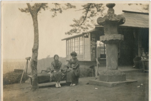 Two women sitting near a store (ddr-densho-296-133)